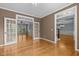 Spacious room with hardwood floors, french doors, and elegant trim at 107 Ashwick Ct, Cary, NC 27513