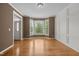 Living room with hardwood floors, bay window, and crown molding at 107 Ashwick Ct, Cary, NC 27513