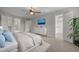 Spacious main bedroom with walk-in closets, ceiling fan, plush carpet, and a white dresser at 107 Ashwick Ct, Cary, NC 27513