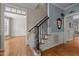 Staircase to second story adjacent to living room and dining room at 107 Ashwick Ct, Cary, NC 27513