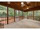 Relaxing sunroom furnished with ceiling fans, skylights and large screened windows with views of mature trees at 107 Ashwick Ct, Cary, NC 27513