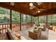 Comfortable sunroom furnished with two sofas, ceiling fans, and large windows overlooking a private backyard at 107 Ashwick Ct, Cary, NC 27513