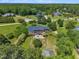 Aerial view of a spacious backyard with a patio, mature trees, and a lush green lawn at 107 Stargrass Ave, Clayton, NC 27527