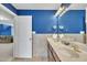 Bathroom with a double vanity, neutral tile, large mirror and access to a bedroom at 107 Stargrass Ave, Clayton, NC 27527