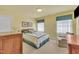 Welcoming bedroom with neutral carpet, a plush armchair, and classic window coverings at 107 Stargrass Ave, Clayton, NC 27527