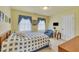 Inviting bedroom with a quilt-covered bed, bright natural light, and classic window treatments at 107 Stargrass Ave, Clayton, NC 27527