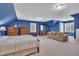 Spacious bedroom features vaulted ceilings, blue walls, carpet, and a large window for natural light at 107 Stargrass Ave, Clayton, NC 27527