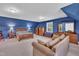Spacious bedroom features vaulted ceilings, blue walls, carpet, large windows and stylish furniture at 107 Stargrass Ave, Clayton, NC 27527