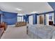 Spacious bedroom with vaulted ceilings, blue walls, carpet, and a view into the ensuite bathroom at 107 Stargrass Ave, Clayton, NC 27527