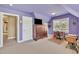 Bonus room with sloped ceilings, plush carpet, and a traditional sewing machine table at 107 Stargrass Ave, Clayton, NC 27527