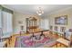 Elegant dining room with hardwood floors, chandelier, and a classic china cabinet at 107 Stargrass Ave, Clayton, NC 27527