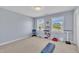 A sunny exercise room features neutral walls, two windows and basic fitness equipment at 107 Stargrass Ave, Clayton, NC 27527