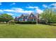 Beautiful brick home with a manicured lawn and lush landscaping at 107 Stargrass Ave, Clayton, NC 27527