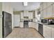 Bright kitchen with stainless steel appliances and plentiful white cabinets at 107 Stargrass Ave, Clayton, NC 27527