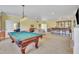 Spacious recreation room with billiard table and ample seating, connected to wet bar at 107 Stargrass Ave, Clayton, NC 27527