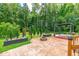 This backyard showcases a stone patio, complete with a stone fire pit and a pergola at 108 Wilson Farm Ln, Clayton, NC 27527