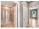 Hall bathroom featuring walk-in shower with glass doors and neutral tile and view into bedroom at 108 Wilson Farm Ln, Clayton, NC 27527