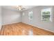Bedroom with hardwood floors, ceiling fan, base molding, and natural light from windows at 108 Wilson Farm Ln, Clayton, NC 27527