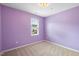 Bright bedroom with neutral carpet, light purple walls, and natural light at 108 Wilson Farm Ln, Clayton, NC 27527