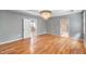 Bedroom featuring hardwood floors, chandelier, tray ceiling, and access to bathroom at 108 Wilson Farm Ln, Clayton, NC 27527