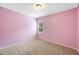Bright bedroom with neutral carpet, light pink walls, and natural light at 108 Wilson Farm Ln, Clayton, NC 27527
