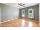 Bedroom with hardwood floors, two windows, ceiling fan, and gray walls at 108 Wilson Farm Ln, Clayton, NC 27527