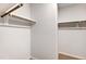 Bright closet with wall-mounted white racks and light brown bars for storage at 108 Wilson Farm Ln, Clayton, NC 27527