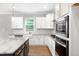 Kitchen featuring island, stainless appliances, and modern white cabinets with brass pulls at 108 Wilson Farm Ln, Clayton, NC 27527