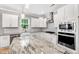 Bright kitchen with granite counters, stainless appliances, white cabinets, and modern fixtures at 108 Wilson Farm Ln, Clayton, NC 27527