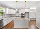Kitchen featuring island, stainless appliances, and modern white cabinets with stainless pulls at 108 Wilson Farm Ln, Clayton, NC 27527