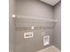 Laundry room area with white wire shelving unit, outlets, and washer/dryer hookups at 108 Wilson Farm Ln, Clayton, NC 27527