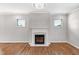 Living room featuring fireplace, two windows, hardwood floors, and modern chandelier at 108 Wilson Farm Ln, Clayton, NC 27527