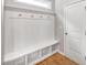 Mudroom featuring built-in bench with storage, hooks, beadboard accent, and door at 108 Wilson Farm Ln, Clayton, NC 27527