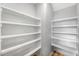 Walk-in pantry with wood-look floor and multiple shelves for ample storage at 108 Wilson Farm Ln, Clayton, NC 27527
