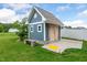 A blue shed in the backyard featuring concrete foundation and wood doors at 108 Wilson Farm Ln, Clayton, NC 27527