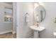 Half bathroom with a pedestal sink, and a decorative mirror at 109 Longchamp Ln, Cary, NC 27519