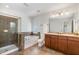 Elegant bathroom with a tiled shower, soaking tub, and dual sink vanity at 109 Longchamp Ln, Cary, NC 27519