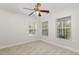 Well-lit bedroom with two windows, carpet floors and a ceiling fan at 109 Longchamp Ln, Cary, NC 27519