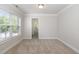 Neutral bedroom featuring plush carpet, large window, and a ceiling light fixture at 109 Longchamp Ln, Cary, NC 27519