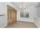 Bright dining area with vinyl flooring, chandelier, and a large window for natural light at 109 Longchamp Ln, Cary, NC 27519