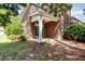 Back of brick home with covered patio overlooking the backyard at 109 Longchamp Ln, Cary, NC 27519