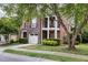 Charming two-story brick home with stone accents, two balconies, and attached garage at 109 Longchamp Ln, Cary, NC 27519