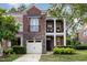 Charming brick townhouse showcasing a two-story facade, stone accents, and a quaint balcony at 109 Longchamp Ln, Cary, NC 27519