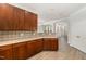 Spacious kitchen with wooden cabinets, light countertops, and open view to the living space at 109 Longchamp Ln, Cary, NC 27519