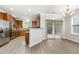 Modern kitchen with stainless steel appliances, tile backsplash, and vinyl flooring at 109 Longchamp Ln, Cary, NC 27519