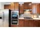 Kitchen featuring stainless steel appliances, gas range and wooden cabinetry at 109 Longchamp Ln, Cary, NC 27519