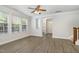 Bright living room with sleek flooring, large windows, and a staircase leading upstairs at 109 Longchamp Ln, Cary, NC 27519