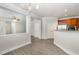 Open-concept living space with modern light fixtures, laminate flooring, and neutral paint at 109 Longchamp Ln, Cary, NC 27519