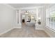 Primary bedroom with columns, tray ceilings, plush carpet, and access to a private bathroom at 109 Longchamp Ln, Cary, NC 27519