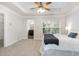 Primary bedroom featuring plush carpet, tray ceilings, large window, and access to a private bathroom at 109 Longchamp Ln, Cary, NC 27519